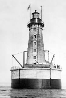 A lighthouse with people standing on top of it

Description automatically generated