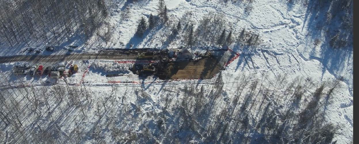 A aerial view of a train in the snow

Description automatically generated